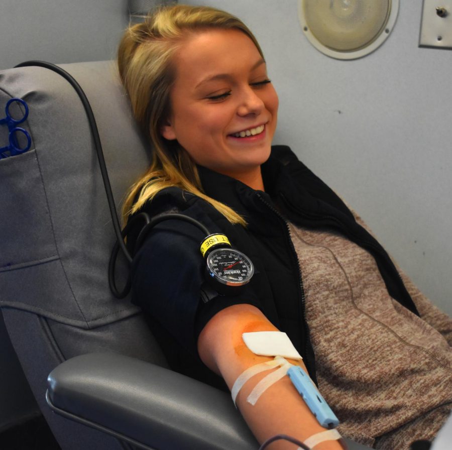 Sophomore+Drew+Urbaniak+smiles+while+getting+her+blood+drawn+for+the+first+time+on+Dec.+15.+%0A