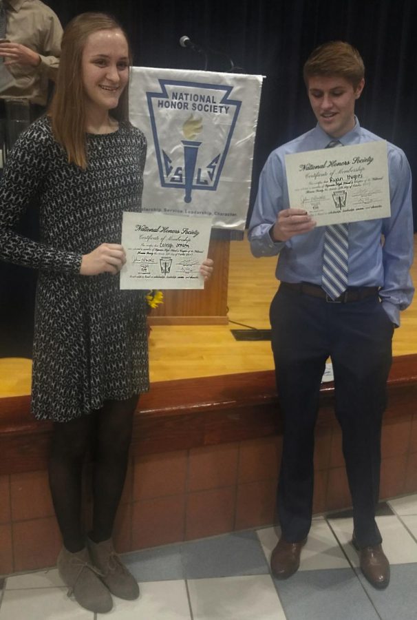 Students Caleigh Jensen and Ryan Hughes receive their National Honor Society members certificates