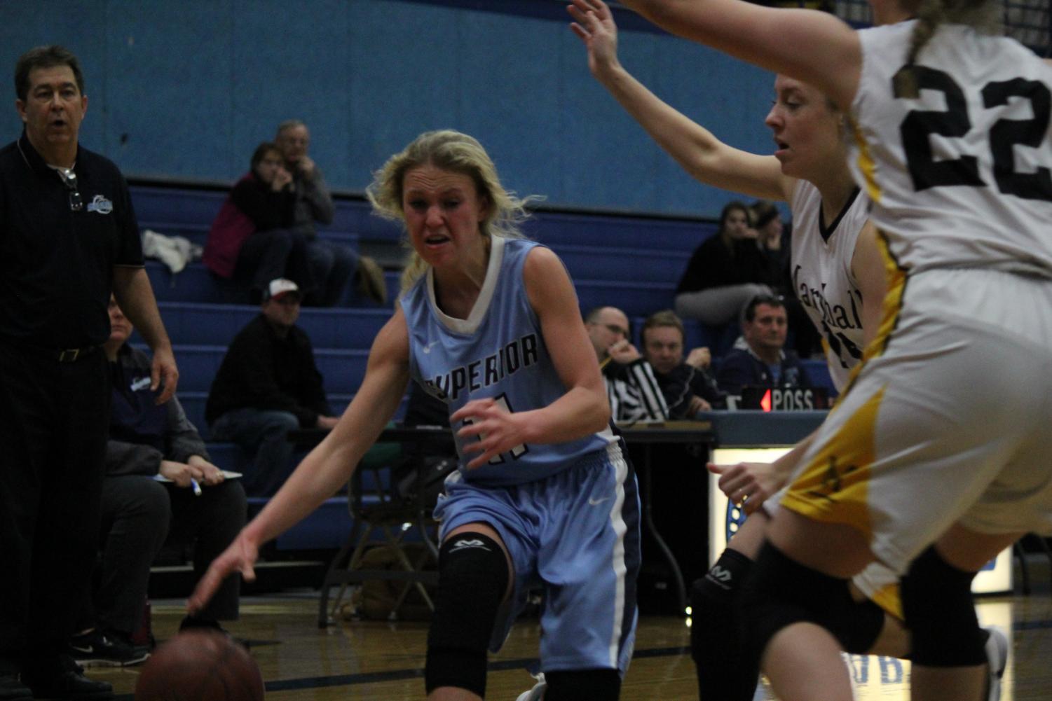 Senior Sophie Kintop dribbles the ball towards the net against Marshall. Spartans lost 30-44 on Monday.