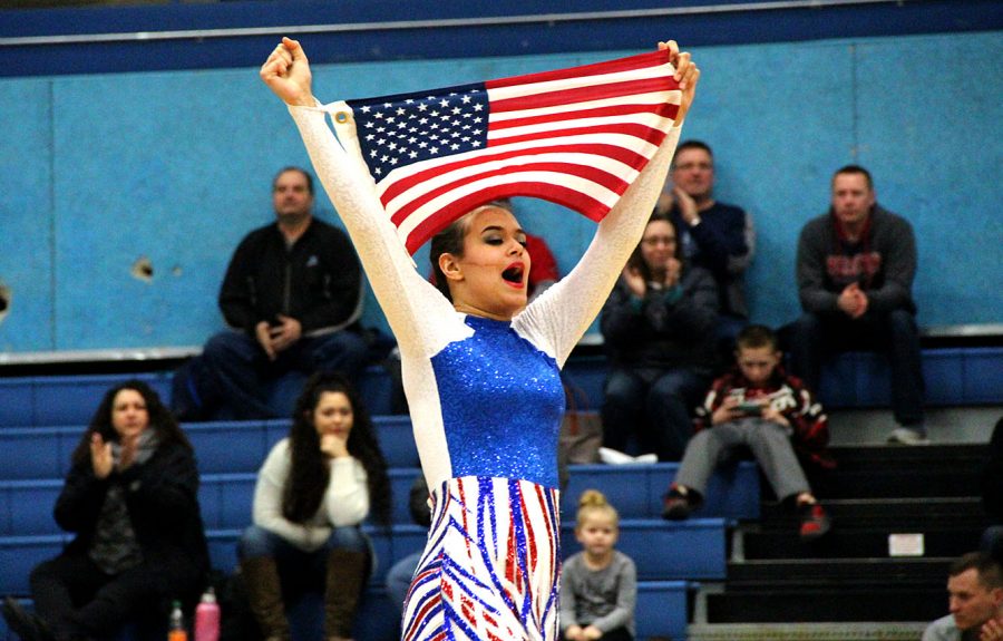  Senior captain Tianna Banks holds the American Flag on Jan. 30 during the varsity kick performance in the SHS gymnasium. 

