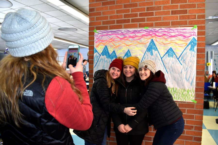 Junior Jaylynn Glaus takes a photo of seniors Fi Robbins, Sarah Cannon and Connie Misfeldt during Monday’s lunch Alaskan Scenery Snapchat Contest.
	
