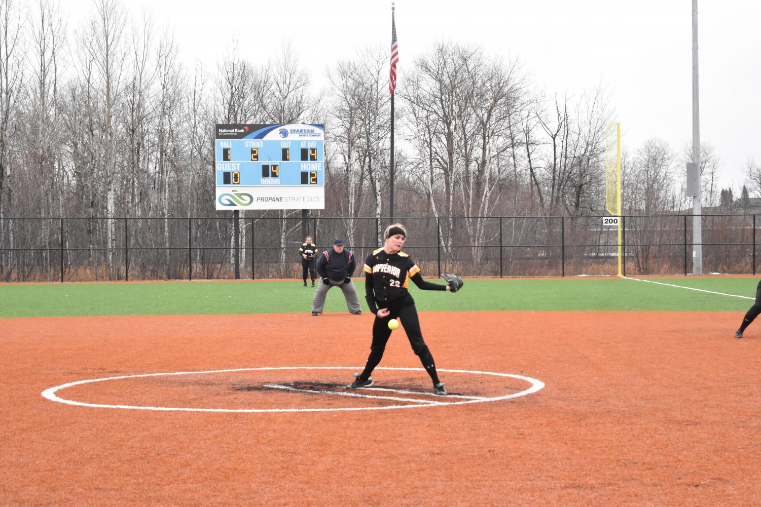 The UWS womens' softball team pitching during a game on the Spartan softball fields.
