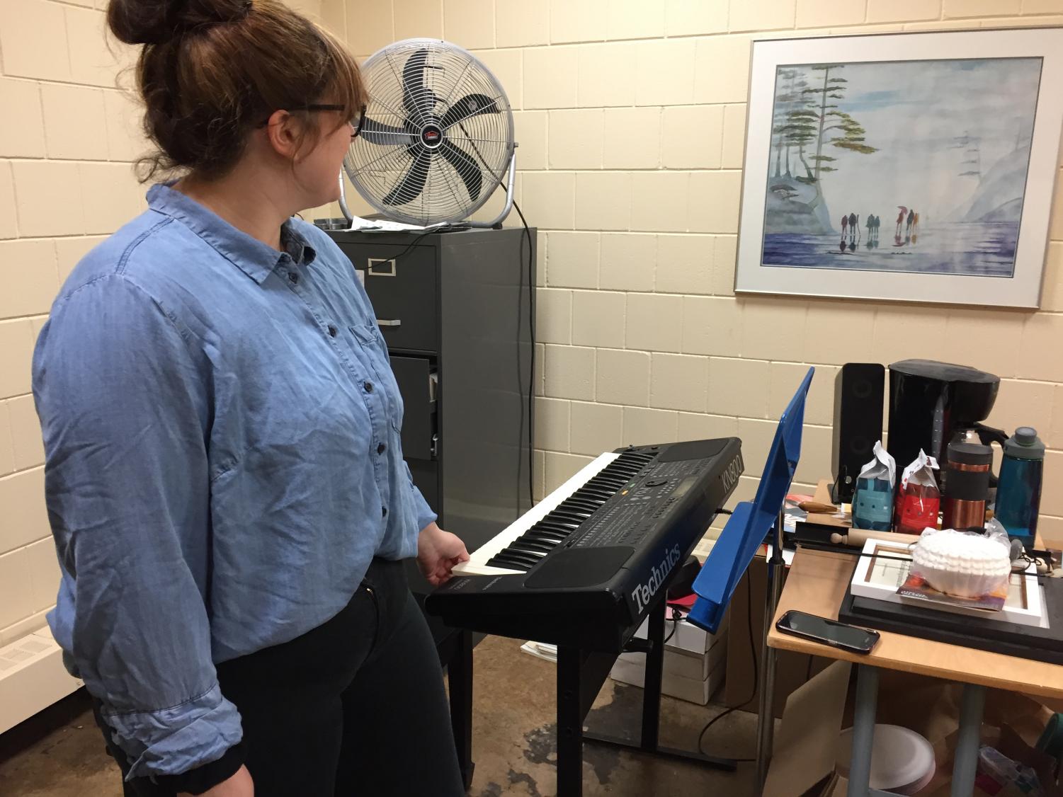 Senior performer Skylar Madsen stands next to a keyboard in the music office on Monday, March 26. Madsen will perform at the Grand March before Prom on April 7.