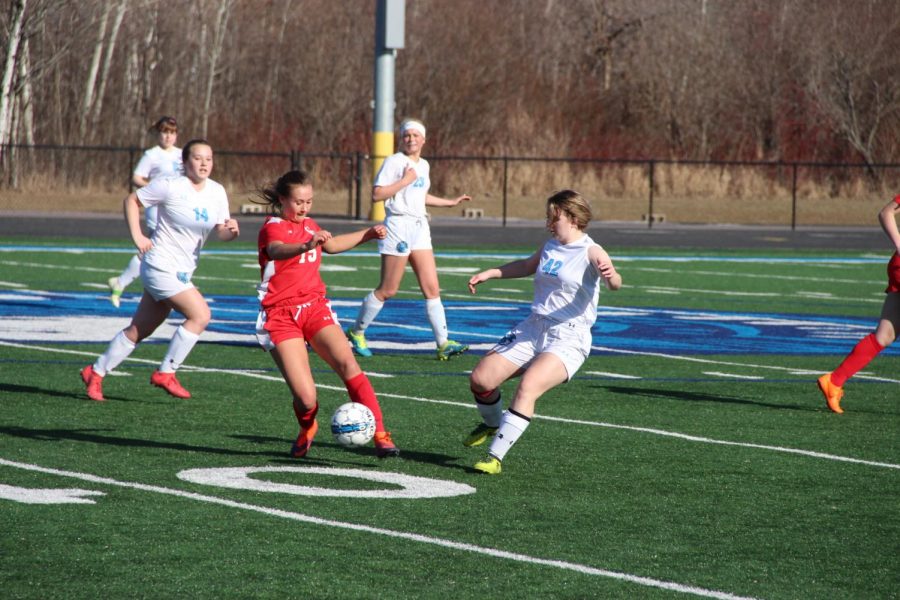 Spartan freshman Bailey Revering fights to get the ball from Chippewa Falls’ junior Adeline Bengtson.
