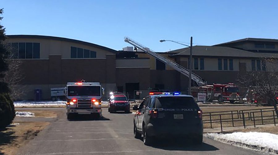 A Superior Police Department car and a Superior Fire Department truck block the street as firefighters put out fire on April 9 at the new Cooper Elementary building on 1642 Pennsylvania Ave.  