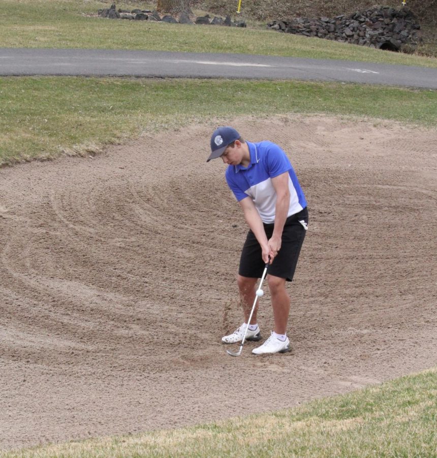 : Sophomore TJ Sitek chips out of the sand on the 10th hole of the south course at Nemadji Golf Course on Wed. May 2.  
