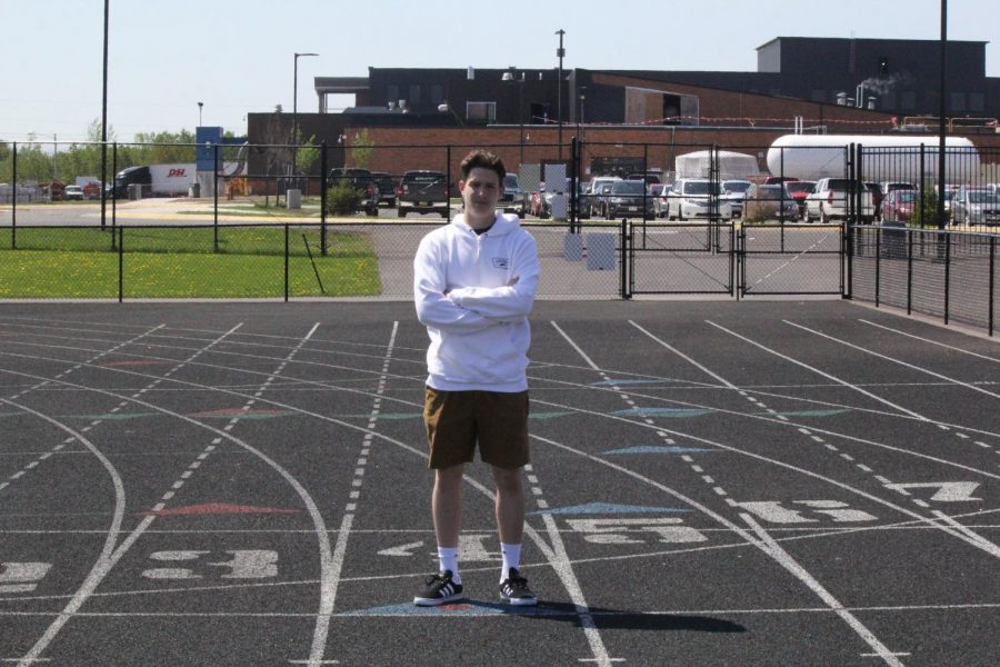 Senior Max Plunkett poses on the track on May 29.
