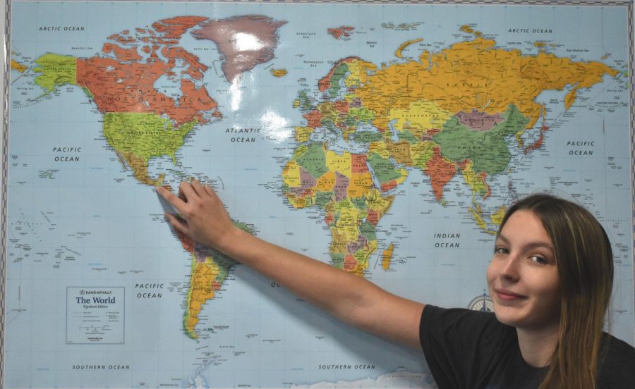 Senior Shanna Smith points at country Guatemala on a world map, displaying what country she is the representative for the Harvard Model United Nations Conference this January.
