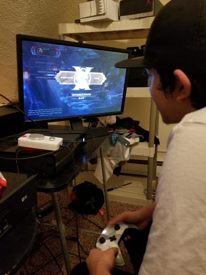 Daniel Villalobos plays Mortal Kombat X at his home on Dec. 8th.