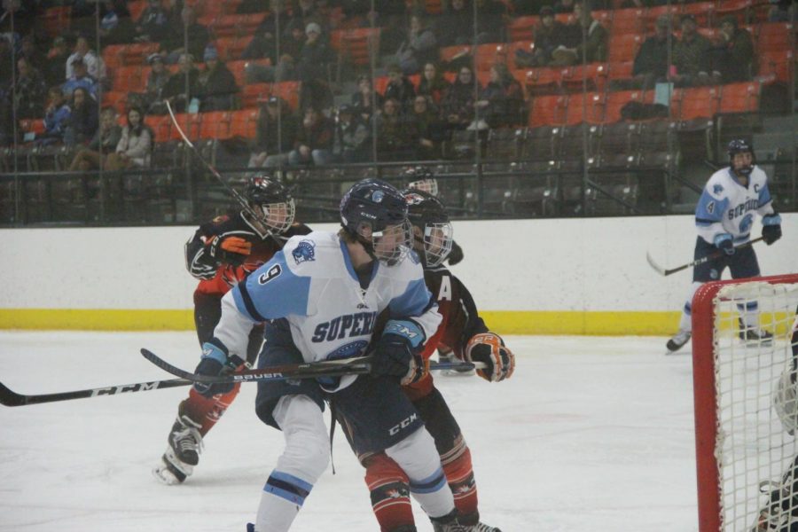 Junior Gunnar Hansen battles for position in front of the net during the first period of a WIAA Section 1 semifinal at Wessman Arena tonight. Superior won 5-0, moving on to face Hudson in the Section 1 final on Saturday.