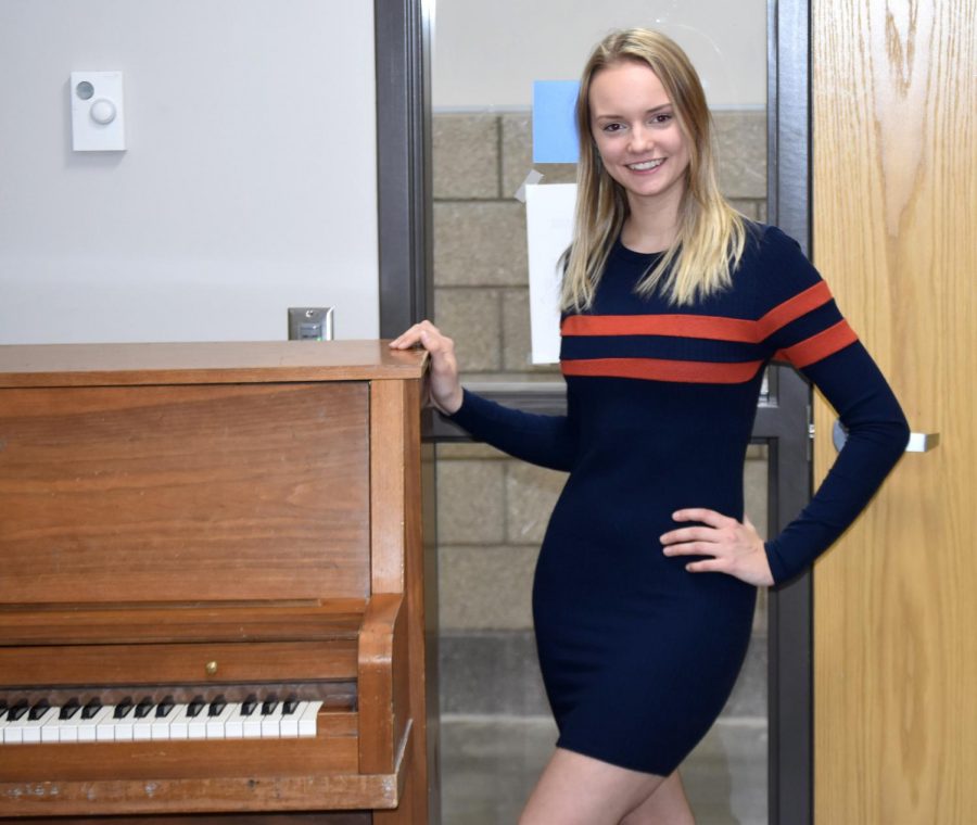 Junior Bella Hanson poses with the piano in the rehearsal rooms at SHS where she practiced for her performance on Feb. 15.
