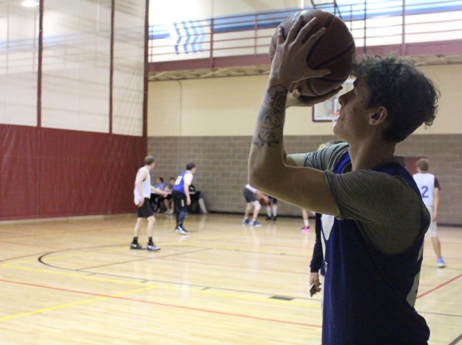 Senior Bryce Scott shoots a basket at the YMCA on Feb. 15. Scott plays and enjoys the recreational league, Friday Night Hoops.
