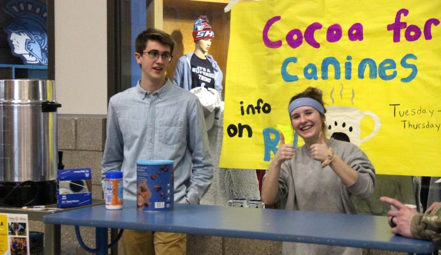 Senior Willem McClellan and junior Claudia Androsky speaking to a potential customer in the Spartan Commons directly outside of the Spartan Shack on Feb. 15. These two Interact students were selling cocoa for funds to be donated to the Douglas County Humane Society.
