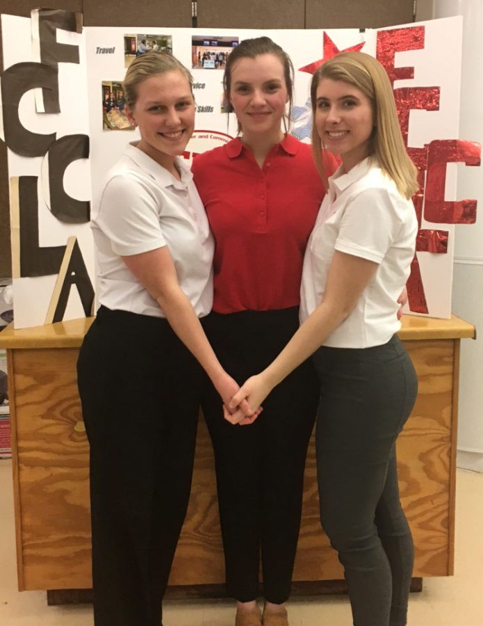 Seniors Gabby Shaul, Jazmine Wilkinson and Macy Misfeldt pose for a photo on Feb. 26 at the regional competition at Northwestern High School.