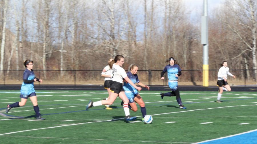Senior Chloe Kintop (2) fights for the ball against Hayward at the NBC Spartan Sports Complex April 2, as sophomore Hannah Drake (left) and senior Megan Jaszczak (11) run beside her. The game ended in a 2-2 draw.