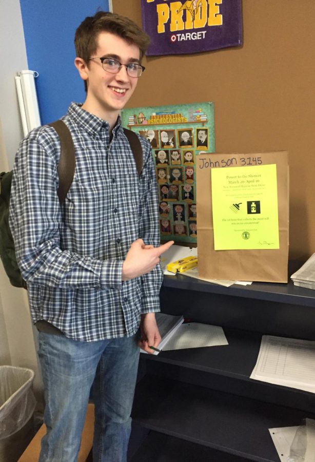 Interact club president senior Willem McClellan looks for donations in Keith Johnson’s class’ donation bag on April 8.