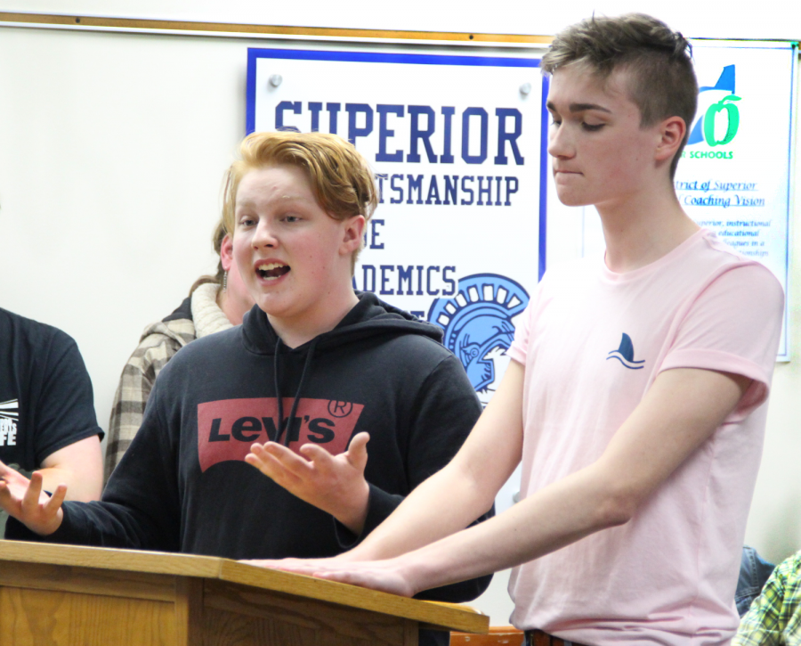 Junior Dylan Schelinder (left) and sophomore Thomas Chicka speak on behalf of the Gay Straight Alliance club at the school board meeting last night at the board office. This meeting had several students, community members, and parents who spoke on the new enforcement of a district policy prohibiting clubs from displaying information in the Spartan Commons during school hours.
