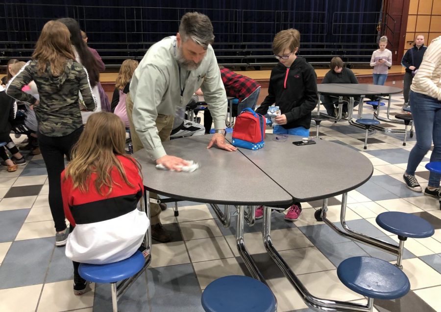 Rick Flaherty, current middle school principal, wipes down a lunch table in the middle school cafeteria on March 22. Flaherty will be moving up to SHS as its new principal for the 2019-2020 school year. 