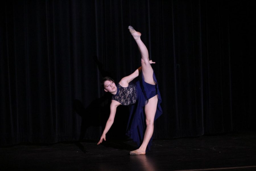 Junior Ivan Zambori does a leg extension during their dance at the Pledgemakers Got Talent show in the Performing Arts Center April 24. Zambori tied for third place with junior Ben Hintzman and freshman Natalie Sandor.