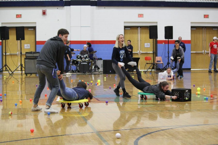 Seniors Maverick Peterson and Shannon McCoshen compete against Satori Rekstad and Katrina Jones in the SHS gym to gather balls during a game of Hungry Hungry Hippos on May 3.