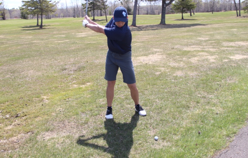 Junior Thomas Sitek follows through with his swing on May 13 at Nemadji Golf Course. 