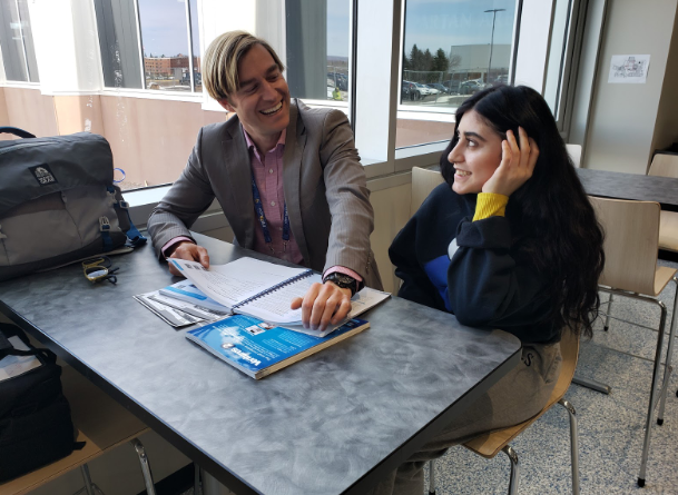  Christopher Pascone sits with junior Lydia Hawatmeh in the commons of Superior High School to discuss lessons during 6th period.
