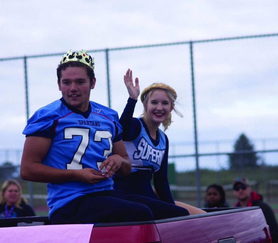 Seniors+Brock+Bergstrom+and+Claudia+Androski+ride+through+the+parade+as+Homecoming+King+and+Queen+Sept.+27