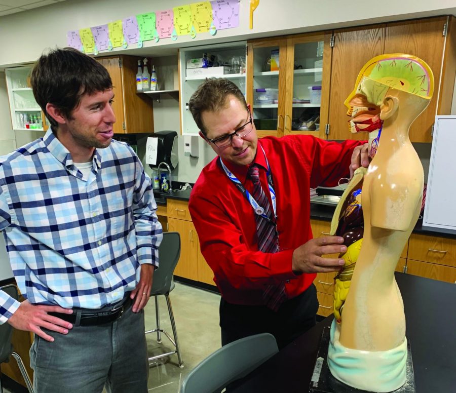 Instructional coach Jason Kalin (right) discusses an upcoming anatomy and physiology lesson with teacher Lee Sims in room 1114, on September 11.
