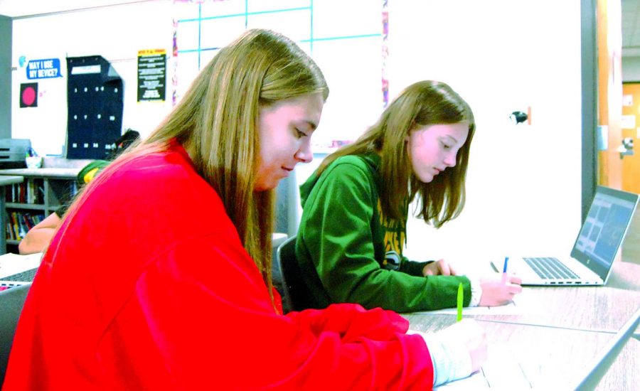Freshman Katie Hughes (left) and freshman Charolette Johnson finish their schoolwork in the extra day of advisory on Sept. 29. 