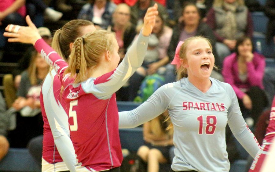 Senior Libero Abby Dolsen and senior Jill Hughes celebrate after a point was scored for the Spartans Oct. 15.
