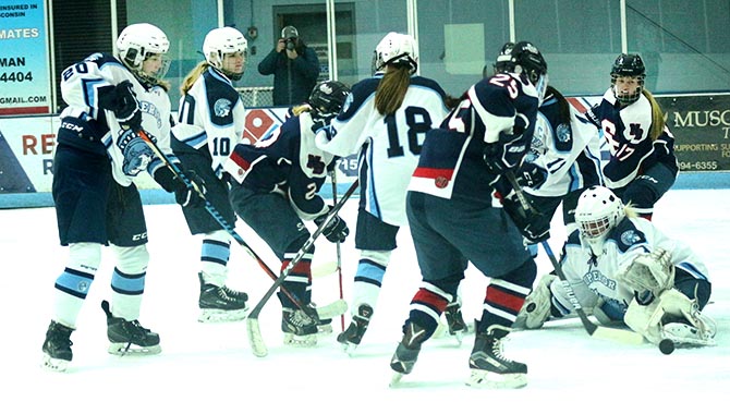 Goalie junior Katrina Casper reaches to stop a puck shot by a St. Francis/North Branch offender late in the first period Nov. 26. Superior won 4-3 in today’s game at Superior Ice Arena(SAHA).