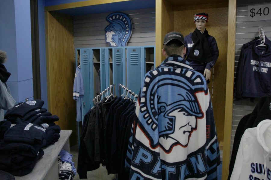 Senior Gunnar Hansen wraps up with the new Spartan blanket in the Spartan Shack Nov. 8.
