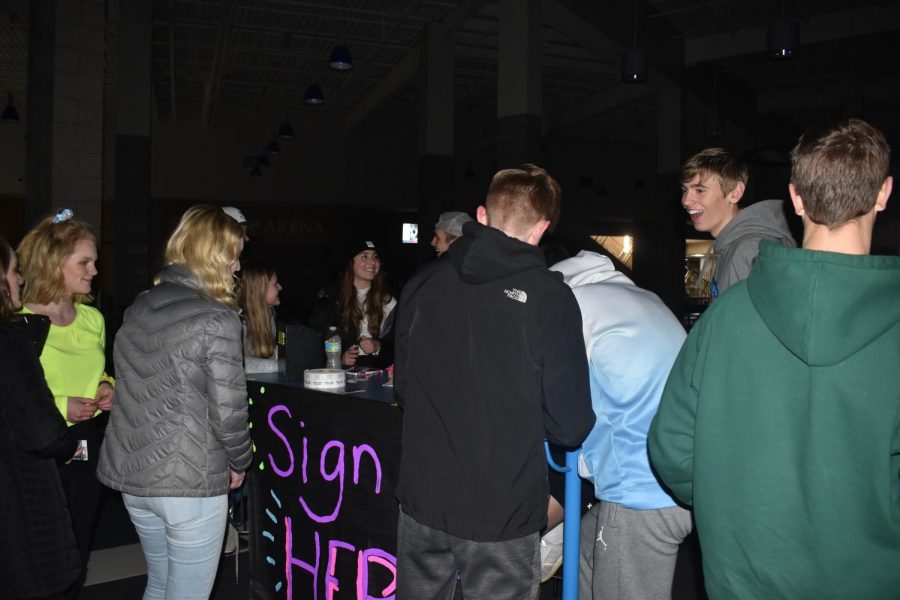 Student+council+members+sign+students+up+the+raffle+that+took+place+at+the+dance+on+Feb.+5.+The+students+would+have+a+chance+to+win+a+pair+of+AirPods+if+they+won.