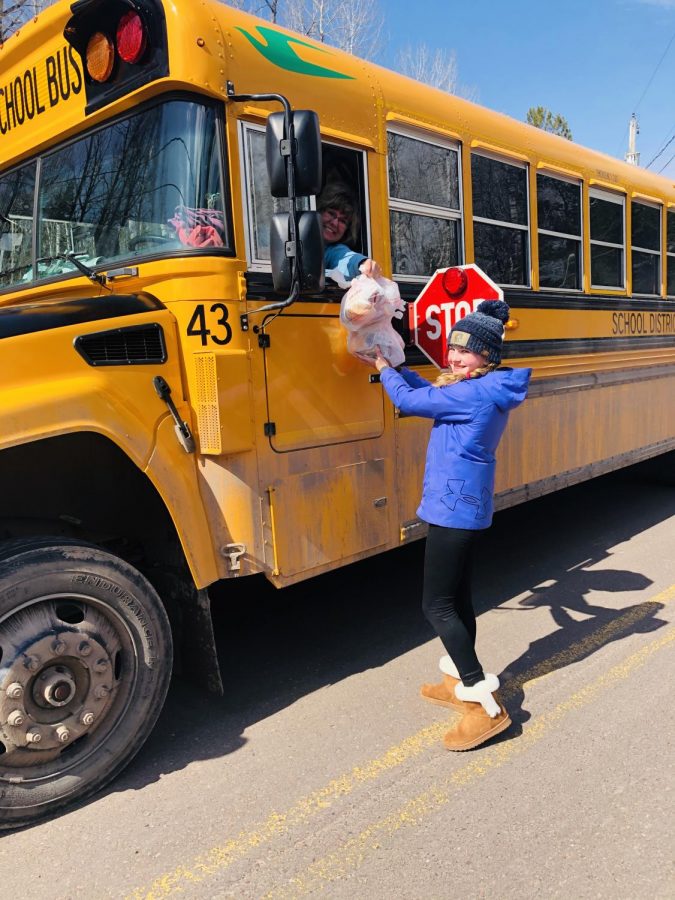  Superior School District bus driver Heidi Lambert delivers a lunch to Jette Leopold, 5th grader at Great Lakes, on her route Monday morning, April 6.