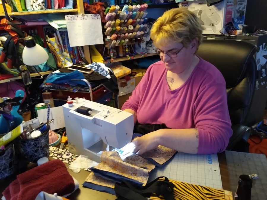 Walmart employee Nickola Boutelle  sews mask from home at her sewing table April 3.