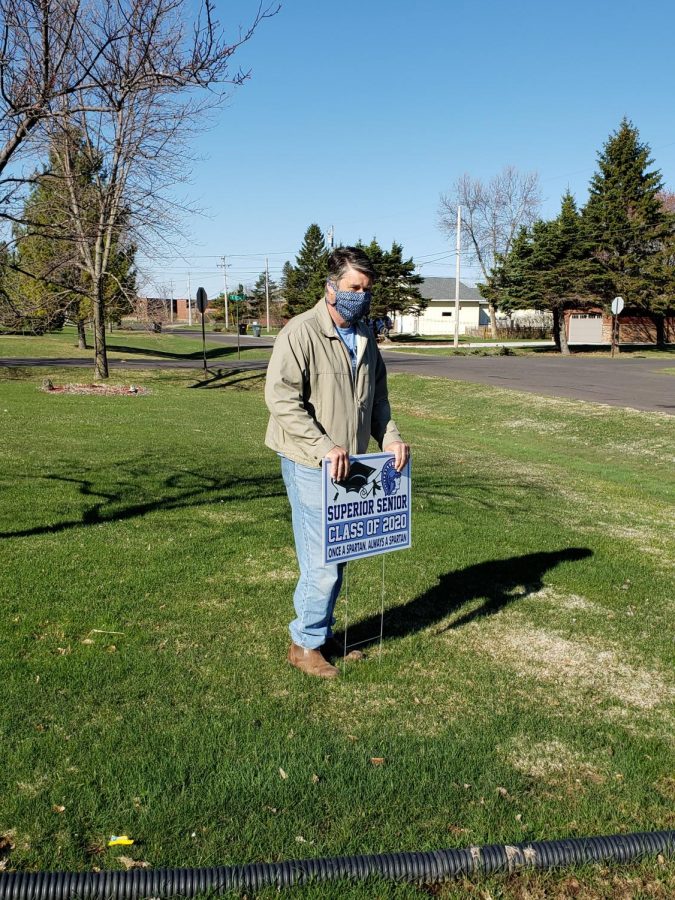 Principal Rick Flaherty places a sign in a Superior yard May, 6. The administration and teachers placed yard signs in seniors yards to show their appreciation and to try to help them celebrate while actual contact or gathering has been suspended for the remainder of the school year.