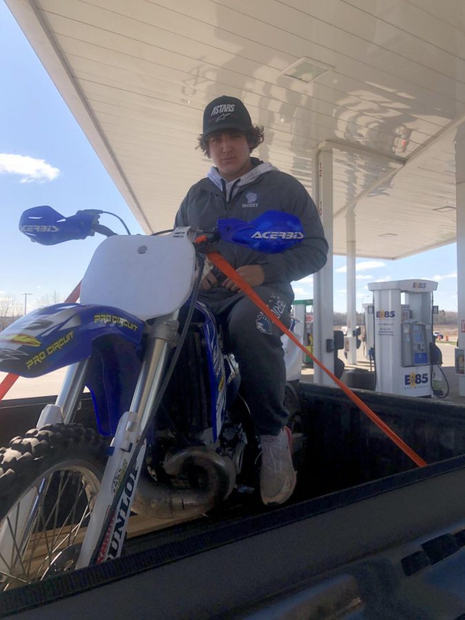  Sophomore Austin Ward sits on his Yamaha Yz250 in the back of a truck May 8. He needed to gas up the bike in city limits, but the law does not allow driving it in the city limits.