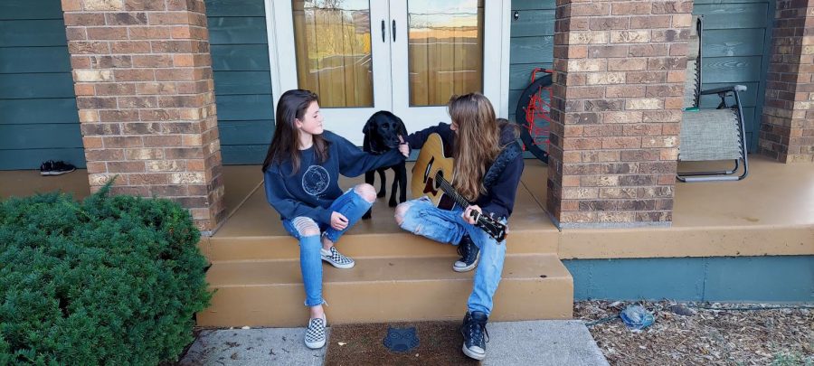 Traxx and his sister Rokkyn sit on their porch while they play one of their new songs Oct. 8. They played and sang respectively the chorus of popular 80’s music.