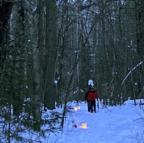 Gary Duzell and his son hike up a luminary-lit trail at the School Forest Feb. 20 after sunset.