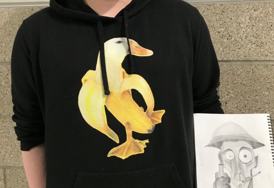 Mackenzie Busche wearing the Banana Duck Sweatshirt, holding their sketch on Tuesday March 9.