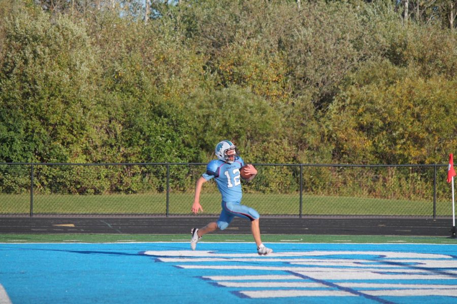 Junior Hayden Smith (12) scores a touchdown in the second quarter in a game against Eau Claire Memorial Sept. 27. Smiths touchdown was one of many scored by Superior in route to a victory over Eau Claire Memorial with the final score being 47-6.