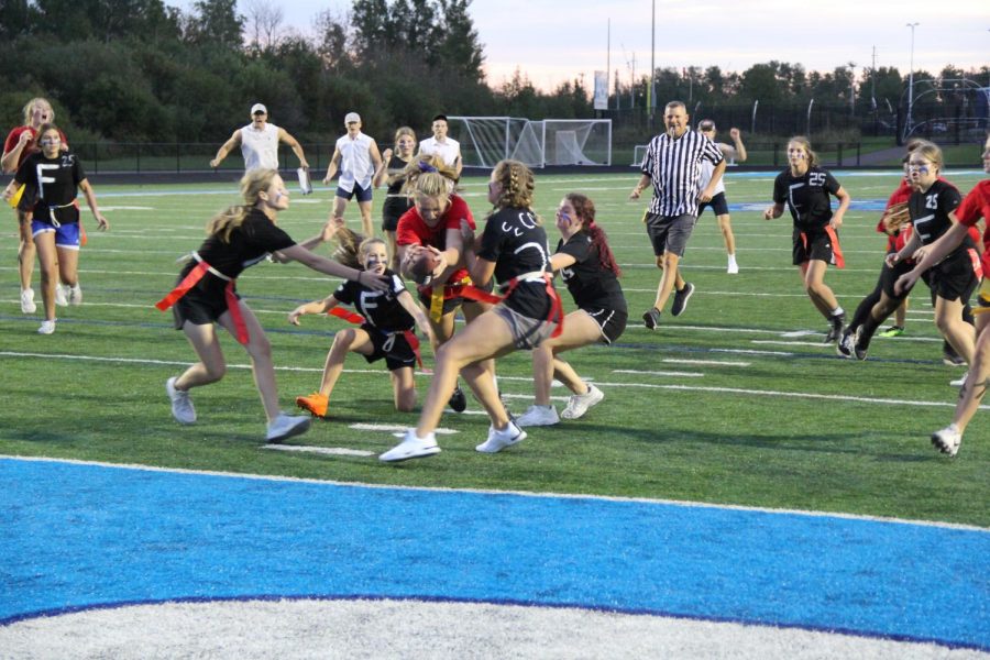Junior Emma Raye dives over freshmen into the end zone Sept. 15. The Juniors ended up losing on a controversial coin flip while being tied 12-12 