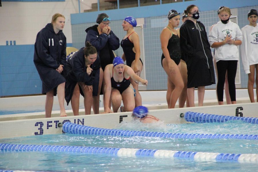 Captain Addie Poskozim and other SHS swimmers cheer and shout on their teammate.