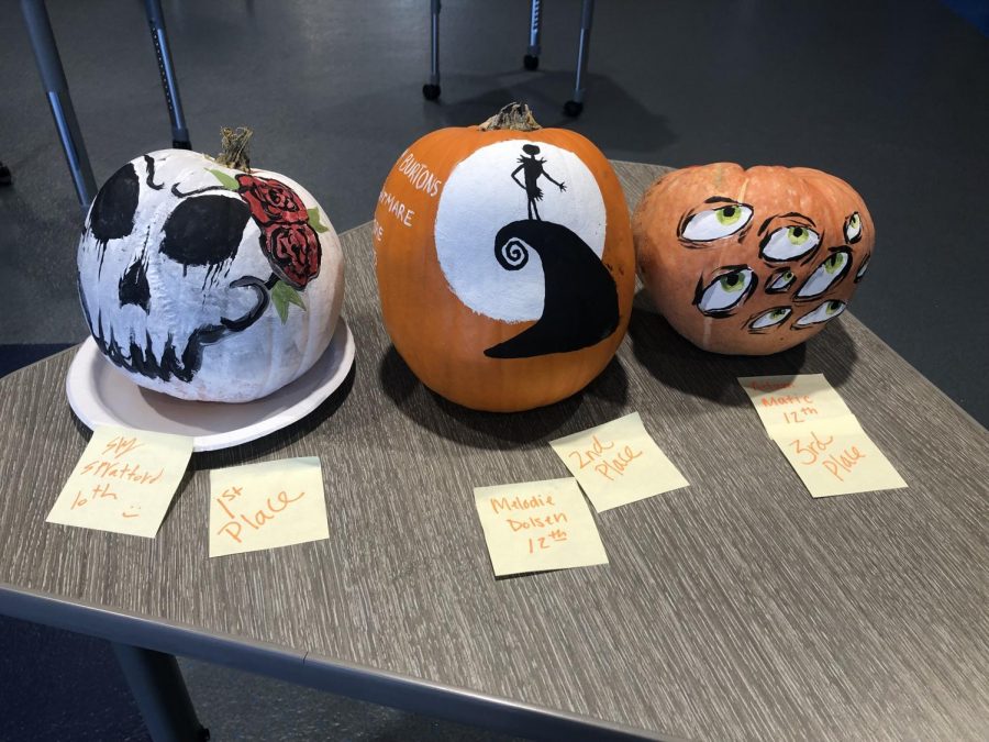 Sky Spratford, Melodie Dolsen, and Adam Matics winning pumpkins can be viewed by the front office.
