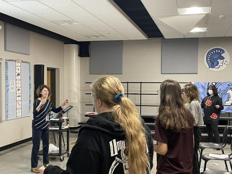  Choir director Jennifer Robbins teaches a choir class, which has returned to in-person learning.
