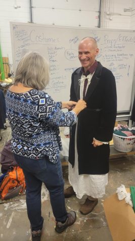 Andy Wolfe was putting on his Ebenezer Scrooge’s costume with the assistance of Tesarek on October 25.