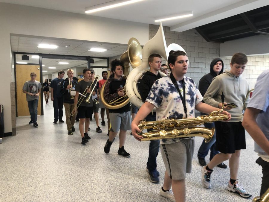 Band students practice their homecoming pieces in the hallways. The band had not played at homecoming in two years.