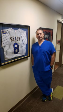 Dr. Matt Thompson poses with his autograph Ryan Braun Jersey in Rochester Minnesota. Thompson came into business teacherTara Hansen’s Careers classes during the school day, Oct.8.