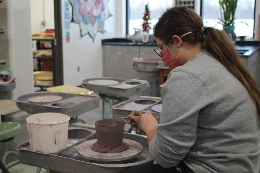 Senior+Gabrielle+Siers+trims+one+of+her+ceramic+pieces+during+her+6th+hour+Ceramics+II+class.