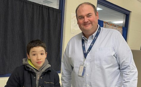 Assistant Principal of the Middle School Aaron Fezzey poses with 8th grader Kacey Bachand on May 3 2022.